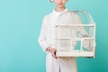 cropped view of girl in white holding cage with parrot Royalty Free Stock Photo