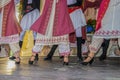 Cropped view of Greek dancers on stage in beautiful embroidered costume with women in front of men - legs and feet - movement blur Royalty Free Stock Photo