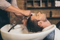 Cropped view hairstylist washing clients hair in barber Royalty Free Stock Photo