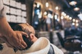 Cropped view hairstylist washing clients hair in barber Royalty Free Stock Photo