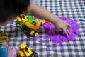 Cropped view of hand cute little boy plays kinetic sand at home Royalty Free Stock Photo