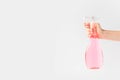 cropped view of hand holding pink spray bottle, Royalty Free Stock Photo