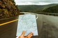 Cropped view of hand holding a tourist map of Cape Breton Highlands National Park Royalty Free Stock Photo