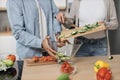 Cropped view of hands of couple standing in modern kitchen cooking salad breakfast or dinner Royalty Free Stock Photo