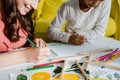 View of happy babysitter drawing with kid in living room Royalty Free Stock Photo