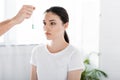 View of hypnotist holding green stone near woman