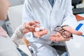 cropped view of kid choosing in glasses or eye lenses Royalty Free Stock Photo