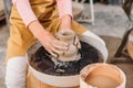 cropped view of kid making ceramic pot on pottery wheel Royalty Free Stock Photo