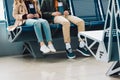 View of kids sitting on blue chairs and holding passports in waiting hall in airport Royalty Free Stock Photo