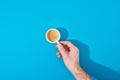 View of man holding cup of fresh coffee on blue background Royalty Free Stock Photo