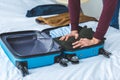 cropped view of man packing clothes into travel Royalty Free Stock Photo