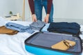 cropped view of man packing clothes into travel bag Royalty Free Stock Photo