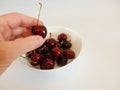 Cropped View of Man Reaching into Bowl of Cherries Royalty Free Stock Photo