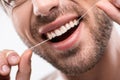 cropped view of man using dental floss Royalty Free Stock Photo