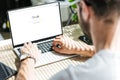 cropped view of man using laptop with google website