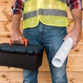 View of mature man holding tool box and blueprint Royalty Free Stock Photo