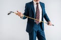 Cropped view of mature man in suit holding golf club isolated Royalty Free Stock Photo