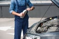 Cropped view of mechanic holding bottle