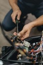 cropped view of mechanic repairing motorcycle