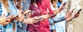 Cropped view on millenial hands using mobile smart phones - People addicted by smartphones - Technology concept