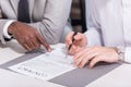 Cropped view of multicultural businessmen signing contract