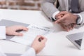 Cropped view of multiethnic businessmen signing contract