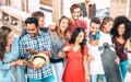 Cropped view of multiracial friends walking in city center - Happy guys and girls having fun at old town streets Royalty Free Stock Photo