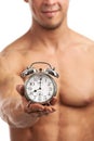 Cropped view of a muscular young man holding clock Royalty Free Stock Photo