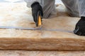 Professional worker in overalls working with rockwool insulation material