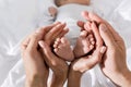 cropped view of parents holding in their hands little baby feet, happy Royalty Free Stock Photo