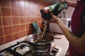 Cropped view of pastry chef or chocolate maker throwing chocolate tablets into water bath to heat and cook melted chocolate mass Royalty Free Stock Photo