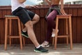 Sportive couple sitting in a cafe enjoying fresh drinks after intensive workout. Royalty Free Stock Photo