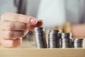 Cropped view of person stacking coins on table Royalty Free Stock Photo