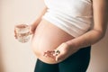 View from side of pregnant woman taking vitamins Royalty Free Stock Photo