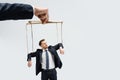 Cropped view of puppeteer holding businessman Royalty Free Stock Photo