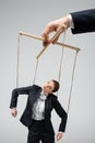 Cropped view of puppeteer holding businesswoman Royalty Free Stock Photo