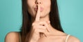 Cropped view of seductive woman with nude lips showing shh symbol Royalty Free Stock Photo