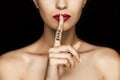 Cropped view of seductive woman with red lips showing shh symbol Royalty Free Stock Photo