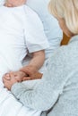 View of senior woman holding hands with sick husband in hospital Royalty Free Stock Photo