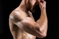 Cropped view of shirtless bearded bodybuilder posing isolated on black