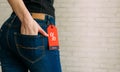 Cropped view slim woman in jeans with label black friday, copy space. Female hands in the back pocket of blue denim pants, close