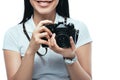 View of smiling brunette asian woman taking picture on digital camera isolated on white Royalty Free Stock Photo