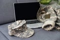 cropped view of soldier camouflage uniform laptop