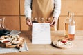 Cropped view of sommelier in apron