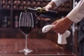 sommelier pouring red wine