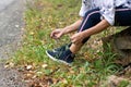 Cropped view of sporty elderly woman tying sport shoes. Active lifestyle Royalty Free Stock Photo