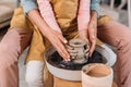 cropped view of teacher and kid making ceramic pot together Royalty Free Stock Photo