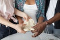 CLose up cropped view of hands of multiethnic family, dad, mom and child playing with dough while making cookies or cake Royalty Free Stock Photo