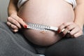 Pregnant woman measuring her belly Royalty Free Stock Photo