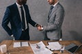 Cropped view of two businessmen shaking hands of each Royalty Free Stock Photo